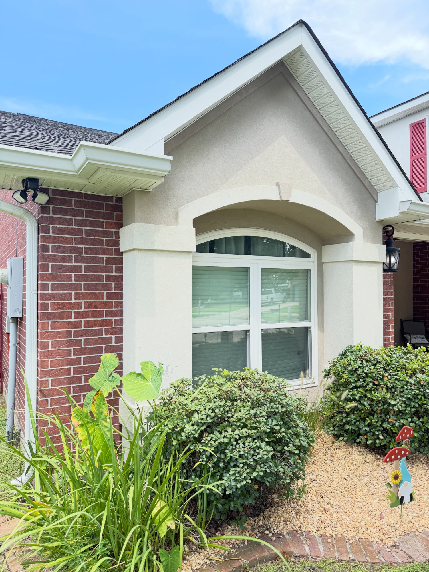 Freshly cleaned stucco exterior and window after soft pressure washing service in Metairie, Kenner, Louisiana by Love Bug Pressure Washing.